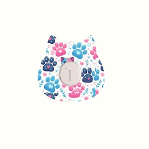 May include: A cat-shaped medical device skin patch with a pattern of blue and pink paw prints, hearts, and floral accents. A silver-colored circular device is centered on the patch. The text "dexcom" is printed on the device.
