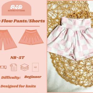 May include: A pair of baby shorts in a pink and white checkerboard pattern, displayed on a woven mat. The image also shows a sewing pattern design for baby flow pants and shorts, with the text "Baby Flow Pants/Shorts" and "NB-5T". The difficulty level is listed as "Beginner".