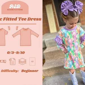 May include: A sewing pattern for a basic fitted tee dress for children. The pattern is available in sizes 0/3 to 9/10. The pattern is labeled as beginner difficulty. The image also shows a child wearing a colorful dress.