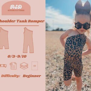 May include: A toddler wearing a one-shoulder leopard print romper and sunglasses. The image also shows a sewing pattern with the text "One Shoulder Tank Romper", size range 0/3-9/10, and difficulty level "Beginner".