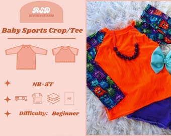 Könnte beinhalten: Ein orangefarbenes Baby-Sport-Crop/T-Shirt mit langen Ärmeln und einem farbenfrohen Monsterdruck. Das Bild enthält ein passendes Stirnband und eine blaue Schleife. Das Design ist für die Größen NB-5T, Schwierigkeitsgrad Anfänger.