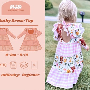 May include: A sewing pattern for a girl's dress or top called "Ruthy Dress/Top". The pattern is available in sizes 0-3 months to 9-10 years. The pattern is for a beginner sewer and includes instructions for making the dress or top. The pattern is shown on a pink background with a drawing of the dress or top in two different colors.
