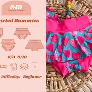 May include: A sewing pattern for Skirted Bummies by RSD Sewing Patterns, featuring a light pink informational card with diagrams and text, alongside a teal fabric garment with a pink heart print and a solid pink waistband for sizes 0/3-9/10.