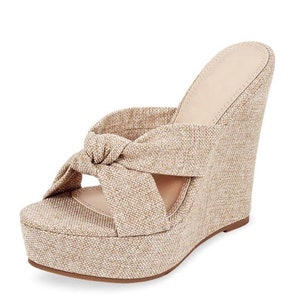 May include: A beige wedge sandal with a knotted strap detail. The platform and wedge heel are covered in a textured fabric. The sandal has a neutral color palette, suitable for various outfits.