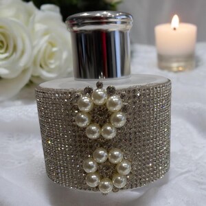White diffuser bottle covered in rhinestones 2 circle pearl gems