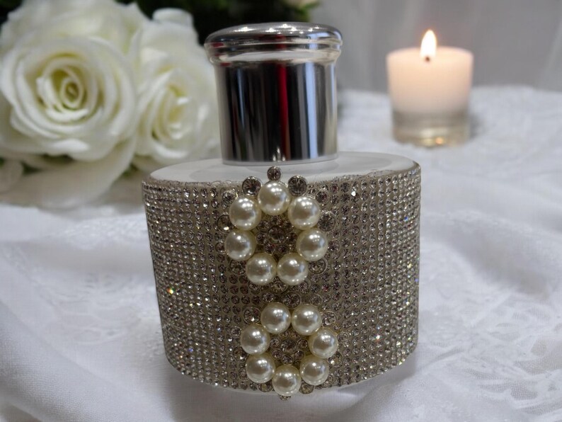 White diffuser bottle covered in rhinestones 2 circle pearl gems