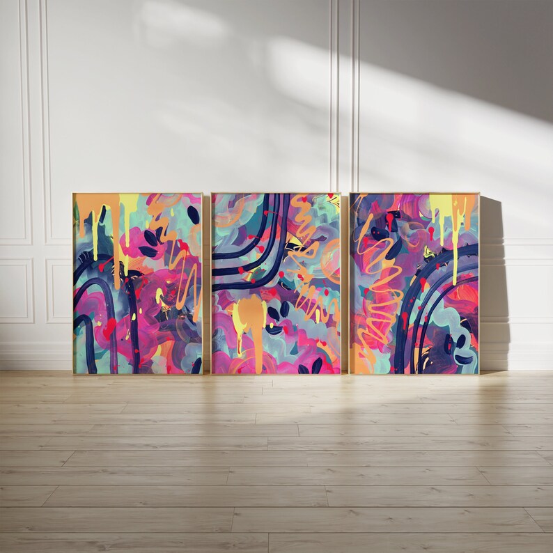 May include: Three abstract paintings in gold frames. The paintings are a mix of pink, purple, blue, yellow, and black. The paintings are all different, but they have a similar style.