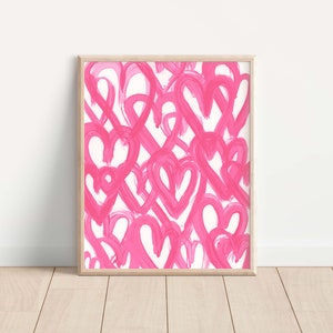 May include: A framed print with a pink and white abstract design featuring multiple overlapping hearts. The hearts are painted in a loose, brushstroke style.