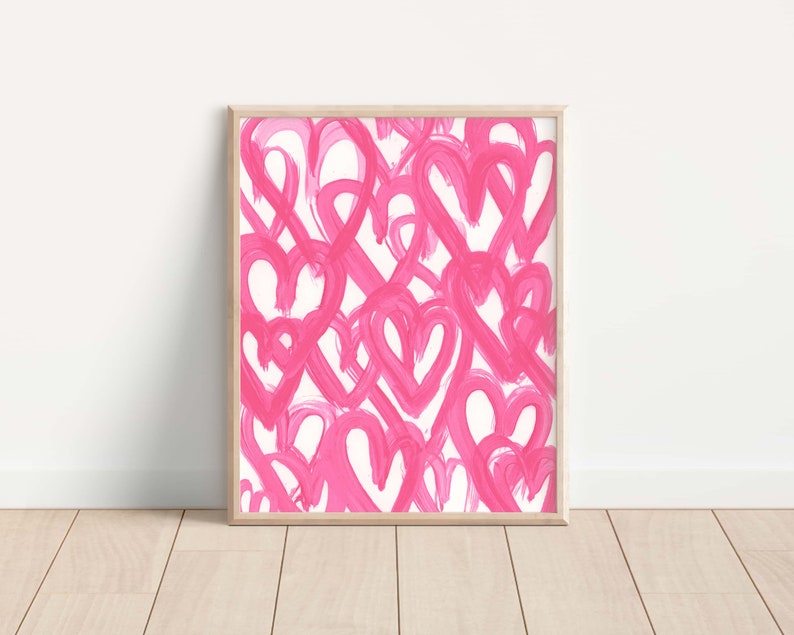 May include: A framed print with a pink and white abstract design featuring multiple overlapping hearts. The hearts are painted in a loose, brushstroke style.