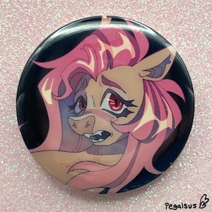 May include: A circular button featuring a cartoon illustration of a horse-like character with pink hair and red eyes. The button has a black background and a glossy finish. The character has a surprised expression.