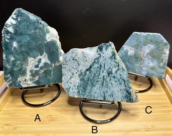 May include: Three green and white agate slabs on metal stands. The slabs are labeled A, B, and C.
