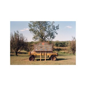 May include: A yellow wagon with a large sign that reads 