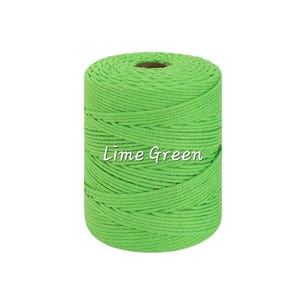May include: A cylindrical spool of lime green macrame cord wound in a tight, continuous pattern. The cord has a twisted texture and a vibrant, solid color. The text "Lime Green" is printed in white across the center of the spool.