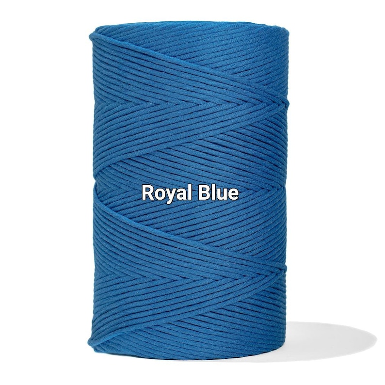 May include: A spool of royal blue cotton cord. The tightly wound cord is a vibrant shade of blue, with the words "Royal Blue" printed on the front. The cord is suitable for various crafting projects.