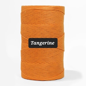 May include: A spool of tangerine-colored cord, tightly wound and textured. The word "Tangerine" is displayed on a black rectangle. The cord is a vibrant orange hue, suitable for various crafting projects.