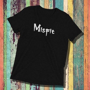 May include: Black t-shirt with the word "Misfit" written in white stylized lettering.
