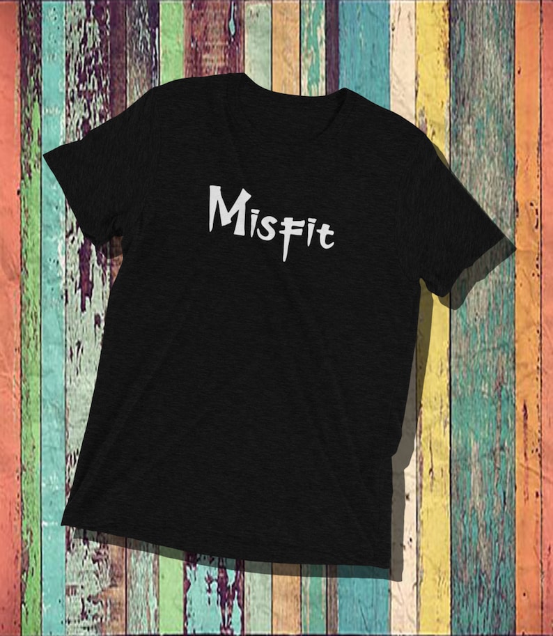May include: Black t-shirt with the word "Misfit" written in white stylized lettering.