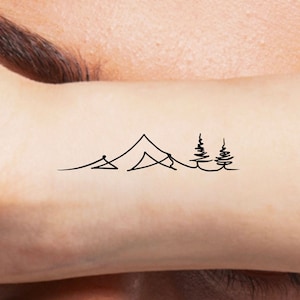 May include: A simple line drawing tattoo design of a mountain range with two pine trees.