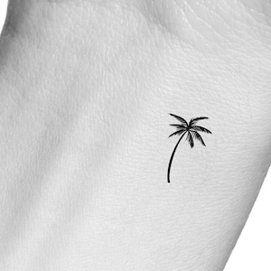 May include: A simple black palm tree tattoo design.