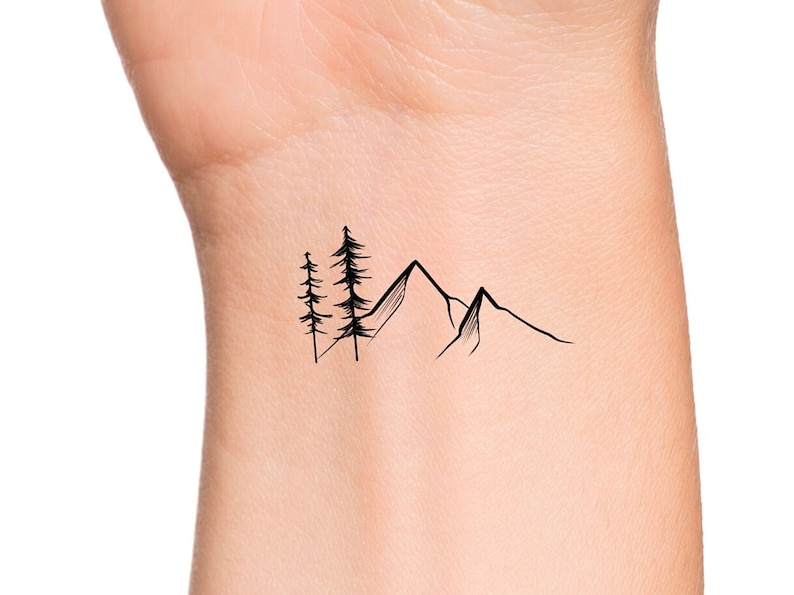 May include: A simple black line drawing tattoo design of a mountain range with three pine trees in front of the mountains.