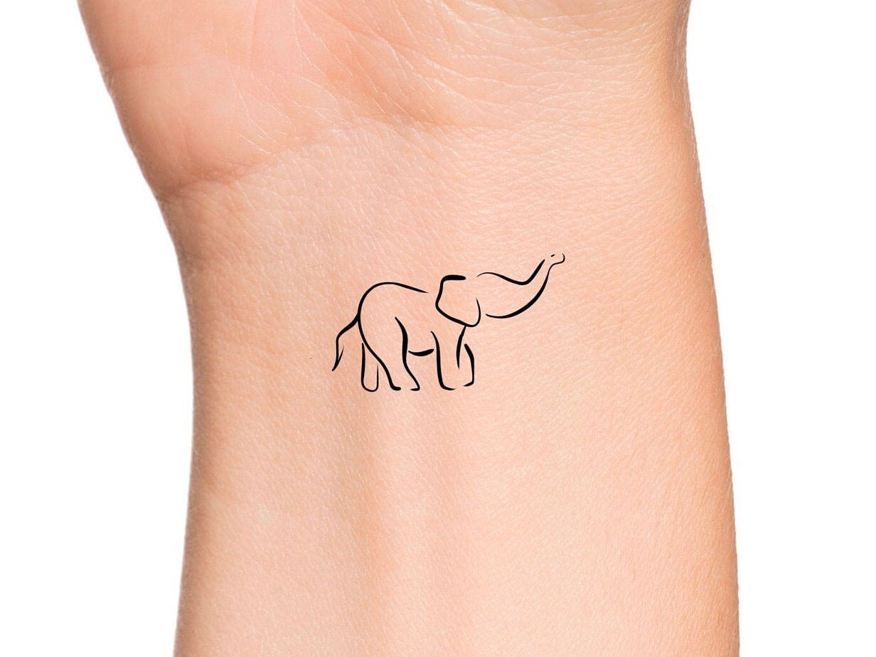 Tiny abstract elephant tattooed on the wrist