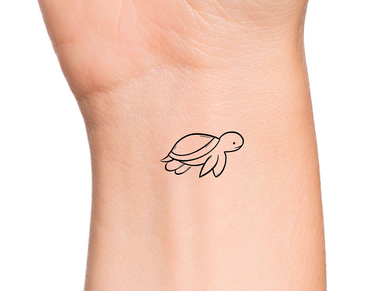 Little turtle tattoo located on the tricep