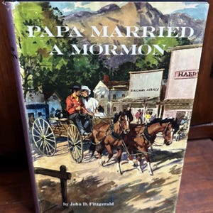 May include: A vintage book cover with the title "PAPA MARRIED A MORMON" above an illustration of a horse-drawn carriage. The illustration depicts a couple in the carriage, with horses, buildings, and mountains in the background.