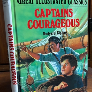 May include: A vintage copy of "Captains Courageous" by Rudyard Kipling from the Great Illustrated Classics series. The book cover features a vibrant illustration of two men on a sailboat, with the title in bold red letters against a green background.