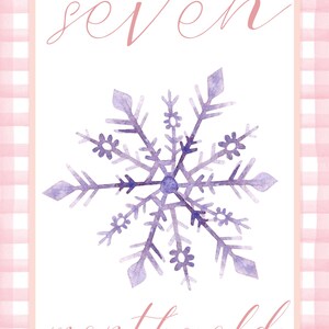 May include: A pink and white gingham border surrounds a white card with the text "seven months old" written in pink cursive. A purple watercolor snowflake is in the center of the card.
