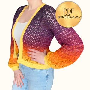 May include: A crocheted cardigan with a gradient color scheme, transitioning from yellow to orange, purple, and back to yellow. The open-front sweater has long sleeves and a yellow trim. A gold circle with the text "PDF pattern" is in the upper right corner.