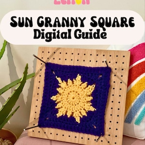 May include: A close-up of a crochet granny square with a yellow sun design in the center. The square is pinned to a wooden board with metal pins. The text "SUN GRANNY SQUARE Digital Guide" is at the top of the image.