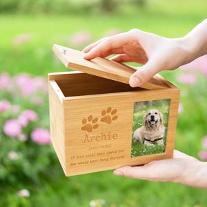 May include: A wooden box with a photo of a dog and the inscription "Archie 2012-2022 If love could have saved you you would have lived forever".