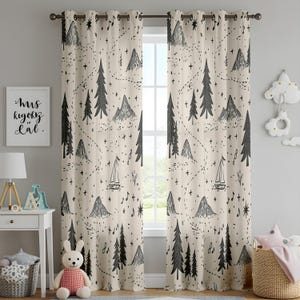 May include: Two beige curtains with grommets featuring a black line-art pattern of mountains, pine trees, sailboats, musical notes, and dotted paths. The fabric hangs from a dark metal rod, displaying a repeating outdoor-themed illustration.