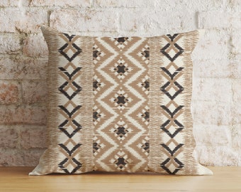 May include: A decorative throw pillow with a geometric pattern in shades of brown and cream. The pillow features a repeating diamond pattern with black accents.