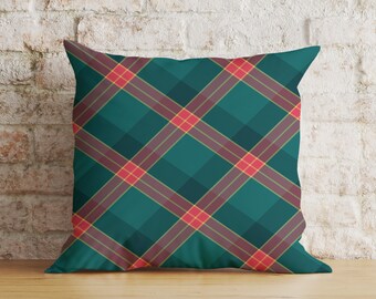 May include: Teal and red plaid throw pillow with a geometric pattern. The pillow is made of soft fabric and has a square shape.