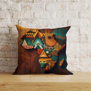 May include: A decorative cushion featuring a colourful geometric design depicting the continent of Africa. The cushion has a brown background with a wood-effect texture and a variety of shapes and patterns in shades of orange, yellow, blue, green, and red.