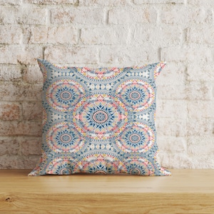 May include: A decorative throw pillow with a blue, yellow, and pink mandala pattern.