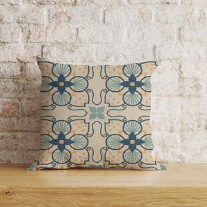 May include: A decorative cushion with a beige background and a repeating pattern of blue, teal, and orange floral designs.