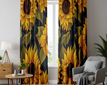 May include: A pair of floor-length window curtains featuring a repeating pattern of large yellow sunflowers with dark brown centers and green leaves set against a deep navy blue background. The curtains are hung on a black rod with grommets.
