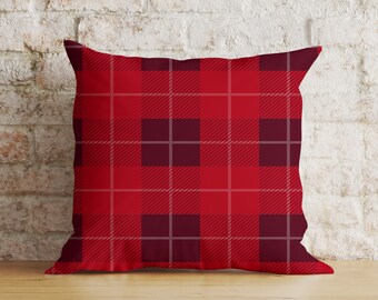 May include: Red and burgundy plaid throw pillow with a square pattern.
