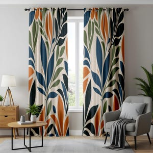 May include: A pair of floor-length curtains featuring a repeating botanical pattern of large leaves in shades of navy blue, olive green, and burnt orange against a cream-colored background, suspended from a black rod with metal grommets.