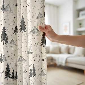 May include: A cream-colored curtain featuring a repeating black line-art pattern of pine trees, mountain peaks, a small sailboat, musical notes, and stars connected by dotted paths. The fabric has a smooth texture and vertical folds.