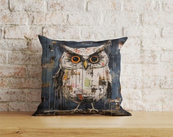 May include: A throw pillow featuring a blue background and a white owl with orange eyes. The owl is painted in a mixed media style with a collage of various textures and patterns.