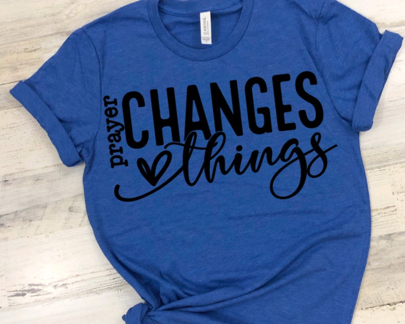May include: A royal blue t-shirt with the text "prayer changes things" in black lettering with a heart symbol.