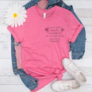 May include: Pink t-shirt with a Christian quote: "Grow in grace and in the knowledge of our Lord and Saviour Jesus Christ 2 Peter 3:18".