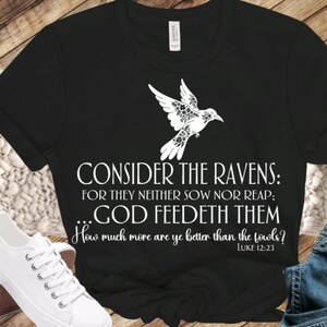 May include: Black t-shirt with a white dove design and the text "CONSIDER THE RAVENS: FOR THEY NEITHER SOW NOR REAP; ...GOD FEEDETH THEM How much more are ye better than the fowls? LUKE 12:23"