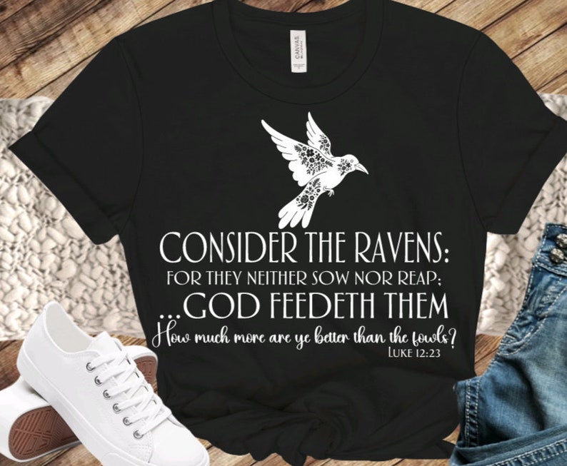 May include: Black t-shirt with a white dove design and the text "CONSIDER THE RAVENS: FOR THEY NEITHER SOW NOR REAP; ...GOD FEEDETH THEM How much more are ye better than the fowls? LUKE 12:23"