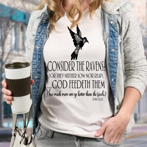May include: White t-shirt with a black silhouette of a bird with flowers and the text "CONSIDER THE RAVENS: FOR THEY NEITHER SOW NOR REAP: ...GOD FEEDETH THEM How much more are ye better than the fowls? LUKE 12:23"