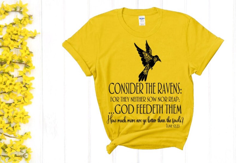May include: Yellow t-shirt with a black raven design and the text "CONSIDER THE RAVENS: FOR THEY NEITHER SOW NOR REAP: ...GOD FEEDETH THEM How much more are ye better than the feels? LUKE 12:23"