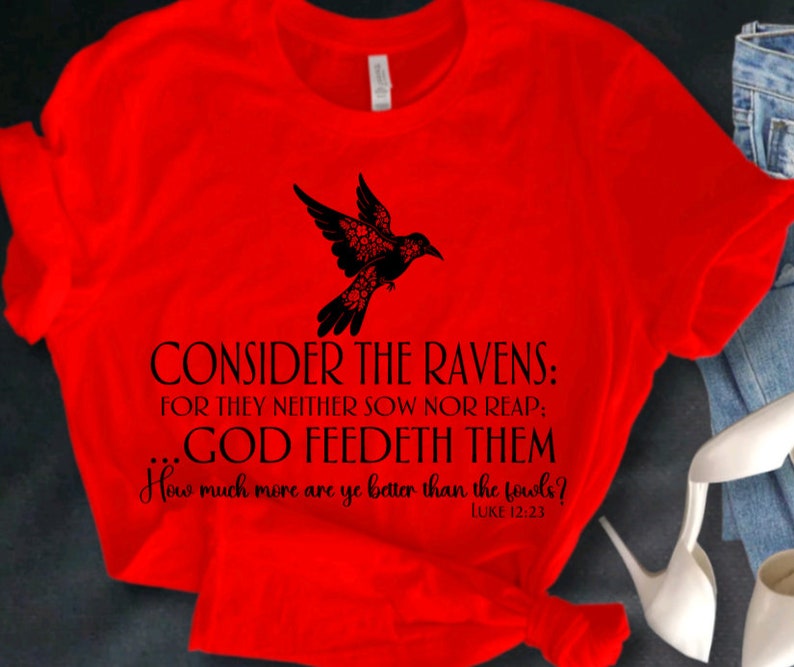 May include: Red t-shirt with a black silhouette of a bird and the text "CONSIDER THE RAVENS: FOR THEY NEITHER SOW NOR REAP: GOD FEEDETH THEM How much more are ye better than the fowls? LUKE 12:23"